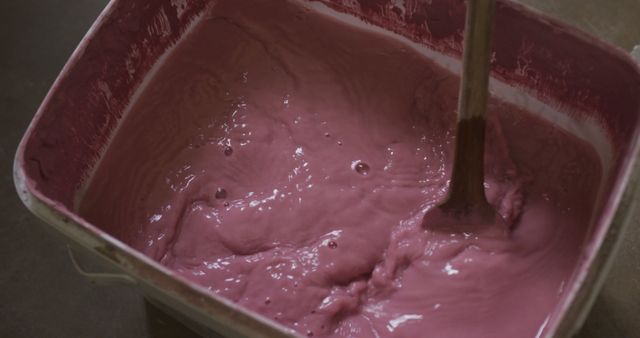 Mixing Pink Paint in Plastic Container with Stirrer - Download Free Stock Images Pikwizard.com