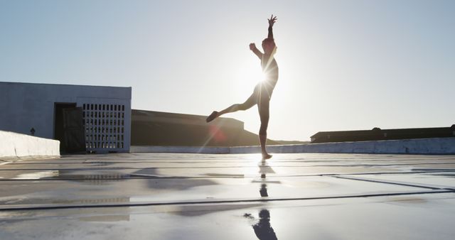 Ballet Dancer Performing on Rooftop at Sunrise with Lens Flare - Download Free Stock Images Pikwizard.com