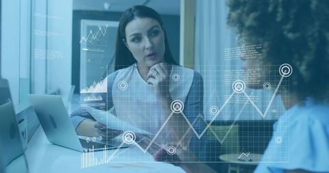 Businesswoman explaining financial data while analyzing digital chart overlay