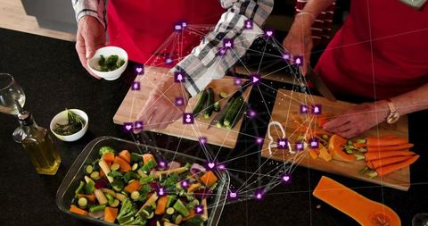 Senior couple preparing vegetables with digital network overlay, healthy cooking lifestyle