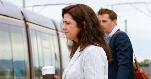 Professionals await morning commute at train station