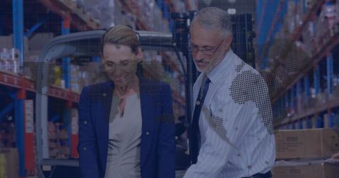 Logistics Professionals Analyzing Inventory in Warehouse Aisle