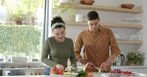 Couple Prepares Healthy Meal with Fresh Vegetables in Modern Kitchen