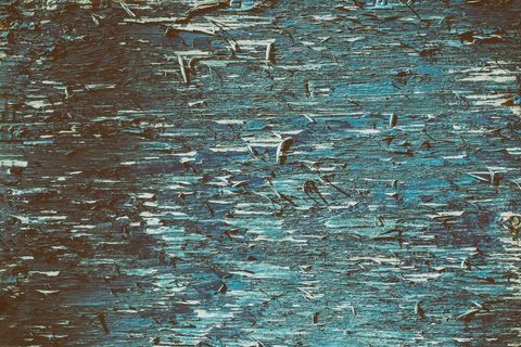 Peeling blue paint on rustic wooden surface