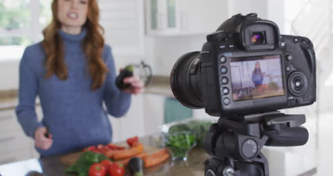 Vlogger Recording Cooking Content in Modern Kitchen