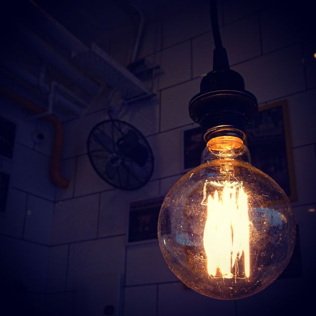 Vintage Edison Light Bulb Glowing in Dark Industrial Space - Download Free Stock Photos Pikwizard.com