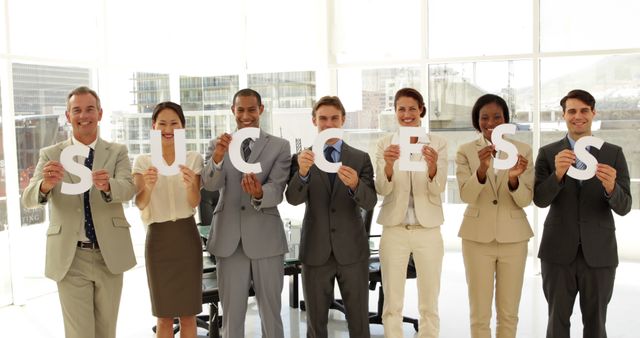 Diverse Business Team Holding Success Sign in Office - Download Free Stock Images Pikwizard.com