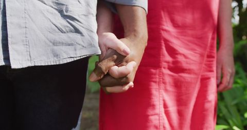 Interracial Couple Holding Hands in Garden