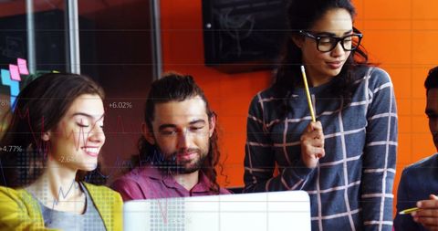 Colleagues collaborating with financial projection overlays in office