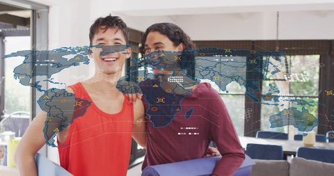 Holding yoga mats smiling together in home wellness scene with augmented reality world map