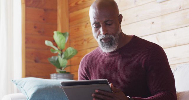 African American Man Reading on Tablet at Home - Download Free Stock Images Pikwizard.com