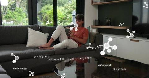 Studying on sofa using tablet with floating math formulas and molecular 3d graphics