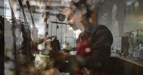 Barista crafting coffee in vintage style café through blurred lights
