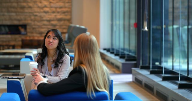 Businesswomen Having Conversation in Modern Office Lounge - Download Free Stock Images Pikwizard.com