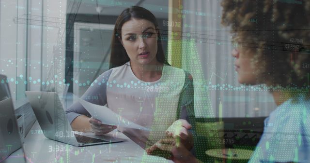 Businesswomen Discussing Financial Reports with Data Visualization Overlay - Download Free Stock Images Pikwizard.com