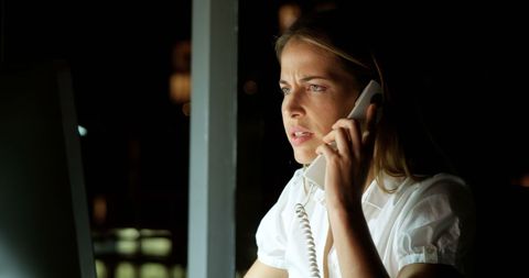Focused Professional Woman on Late Night Business Call