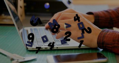 Hands typing on laptop keyboard with floating numbers overlay for data entry and coding
