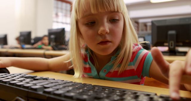 Young Girl Learning to Type on Computer Keyboard in Classroom - Download Free Stock Photos Pikwizard.com