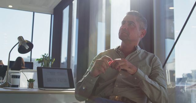 Pensive Businessman Sitting in Modern Office During Daytime - Download Free Stock Images Pikwizard.com