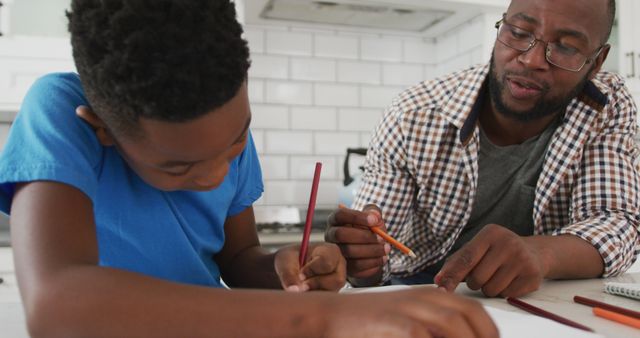 Father and Son Drawing Together in Kitchen - Download Free Stock Images Pikwizard.com