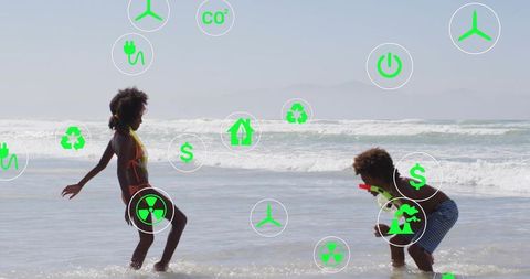 Children playing on beach with green sustainability icons representing renewable energy