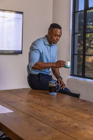 Businessman Enjoying Coffee Break in Modern Office Environment