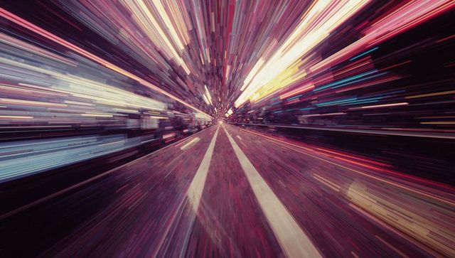 Dynamic night street with vibrant light streaks