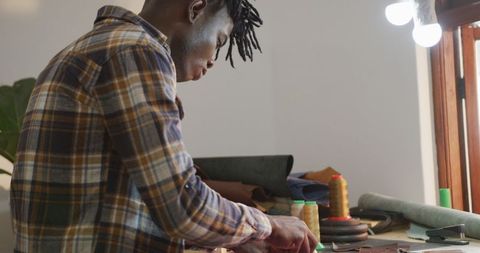 Focused Craftsman Skillfully Working in Leather Workshop