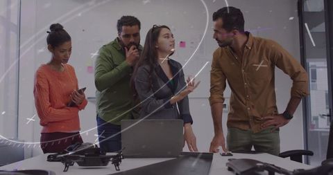 Diverse Team Discussing Innovative Tech in Modern Office