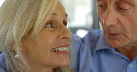 Senior Couple Sharing Happy Moment on City Bus