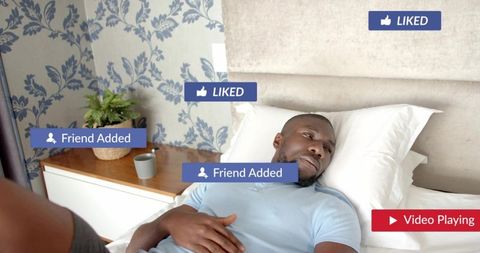 Reclining man scrolling smartphone on bed with social media notifications and video badge