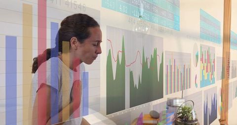 Female professional analyzing data charts in modern workspace