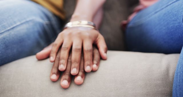 Holding hands of african american couple at home. Lifestyle, relationship, togetherness, free time and domestic life, unaltered.