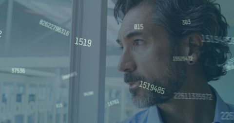 Businessman Contemplates with Digital Numbers Overlay on Window