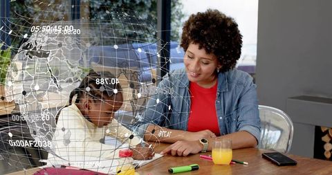 Tutor guiding child writing homework at home table with futuristic global data overlay