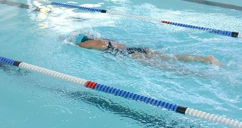 Professional Swimmer Competing in Pool Race