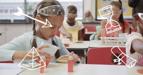 Young girl pouring orange solution into petri dish while wearing goggles in science class
