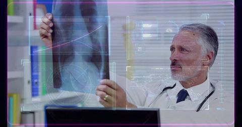 Senior physician examining hip x-ray with medical hud overlay confirming pelvic fracture