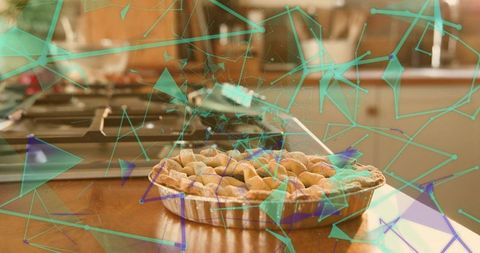 Lattice pie on kitchen counter near stove with teal network overlay, smart kitchen concept