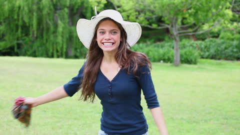 Joyful Brunette Woman Spinning in a Sunlit Park