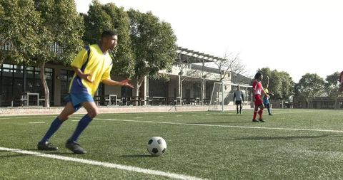 Dynamic Soccer Players Practicing on Sunny Green Field