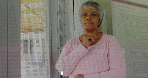 Senior woman overlaid by digital edit and numbers