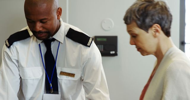 Security Officer Assisting Senior Woman in Office - Download Free Stock Images Pikwizard.com