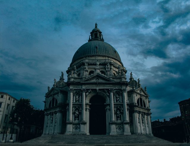 Imposing historic domed architectural building captured in the evening with a dramatic, cloud-filled sky. Perfect for use in travel guides, historical architecture articles, tourists'/travellers' brochures, and educational materials on heritage and classical architecture.