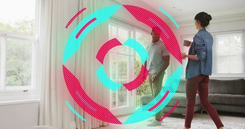 Couple inspecting sunlit living room by french doors holding mug, modern sofa and curtains