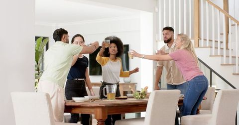 Diverse Friends Socializing Around Dining Table at Home