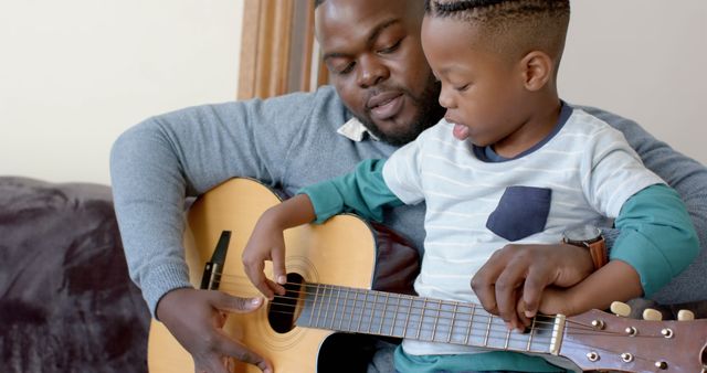 African American Father and Son Bond Playing Guitar at Home - Download Free Stock Images Pikwizard.com