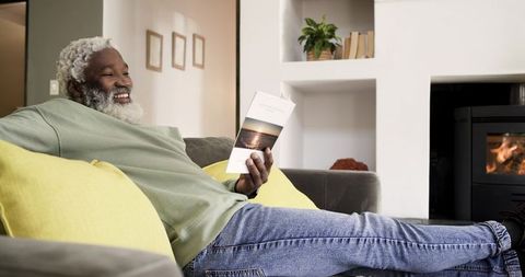 Senior Man Relaxing at Home Reading Brochure