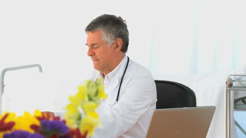 Doctor Analyzing Patient's Scan in Office Environment