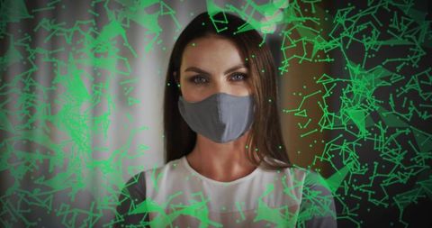 Woman wearing gray cloth mask with futuristic green holographic network overlay